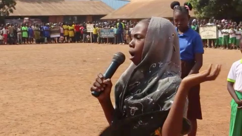 During a Bangui cultural week peace education workshop with the Aegis Trust Central African schoolchildren perform a sketch about the need for orphans to go to school